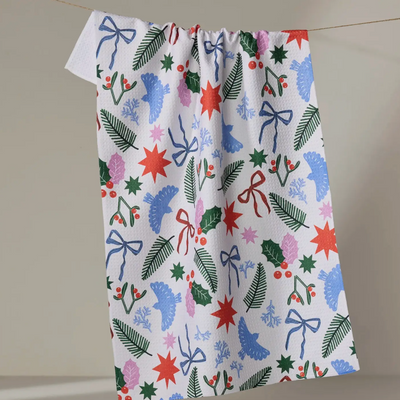 Festive tea towel with colorful patterns on a plain background